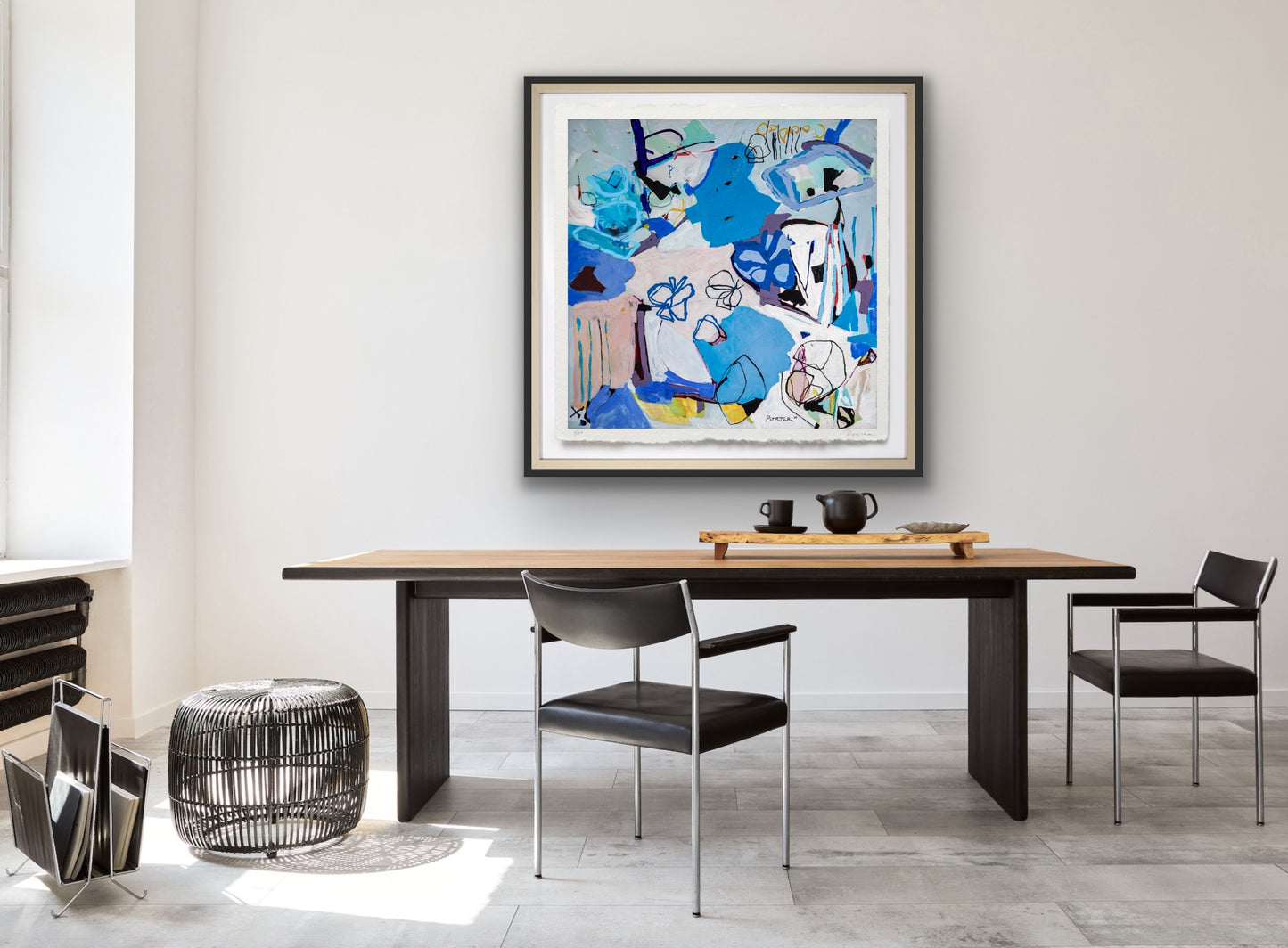 Dining room with a wooden table, chairs, and a colorful abstract painting on the wall.