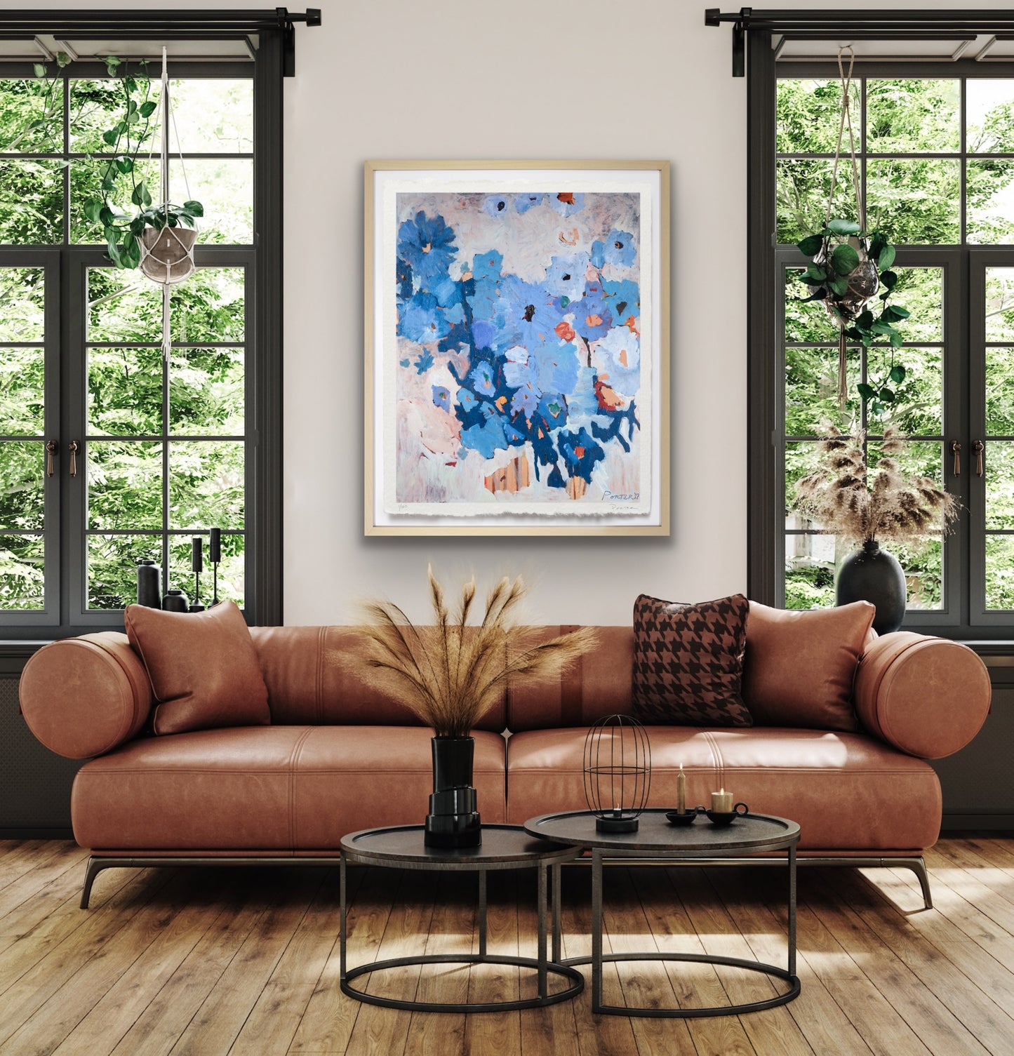 Modern living room with a brown leather sofa, round coffee tables, and abstract art on the wall.