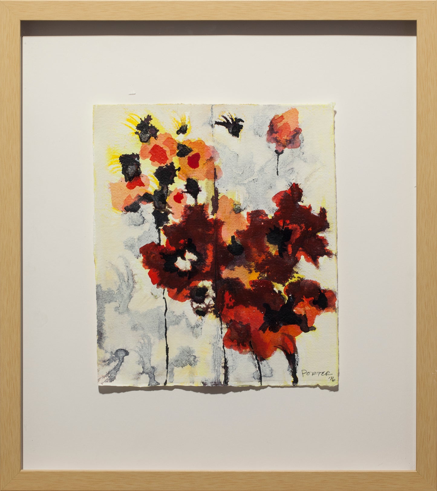 Framed abstract artwork with red, black, and yellow colors on a light background