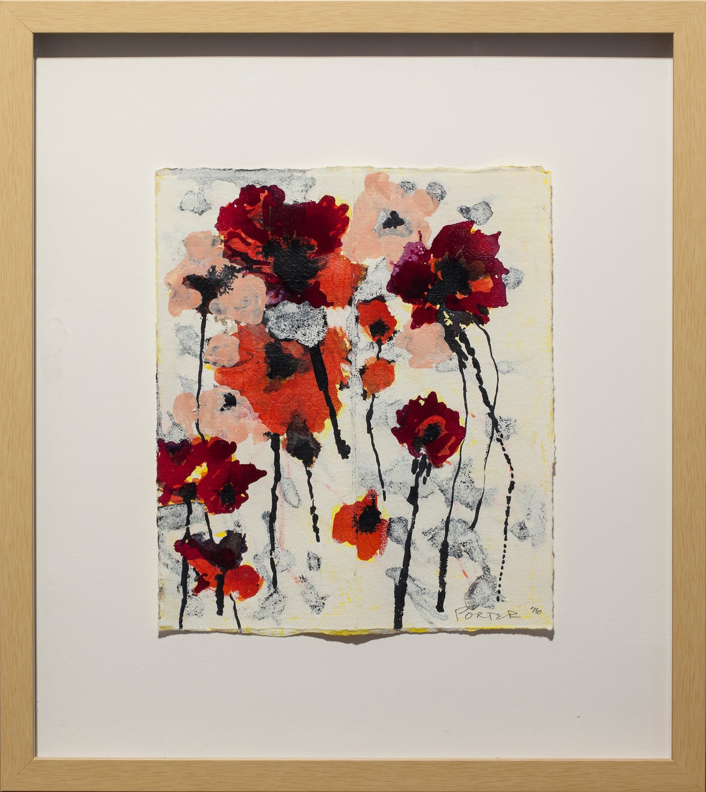 Framed abstract artwork of colorful floral design on a beige background