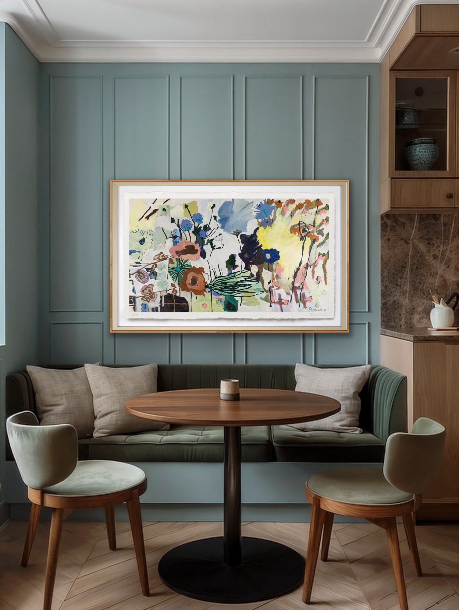 Modern living room with a round wooden table, chairs, and a colorful abstract painting on a green paneled wall.